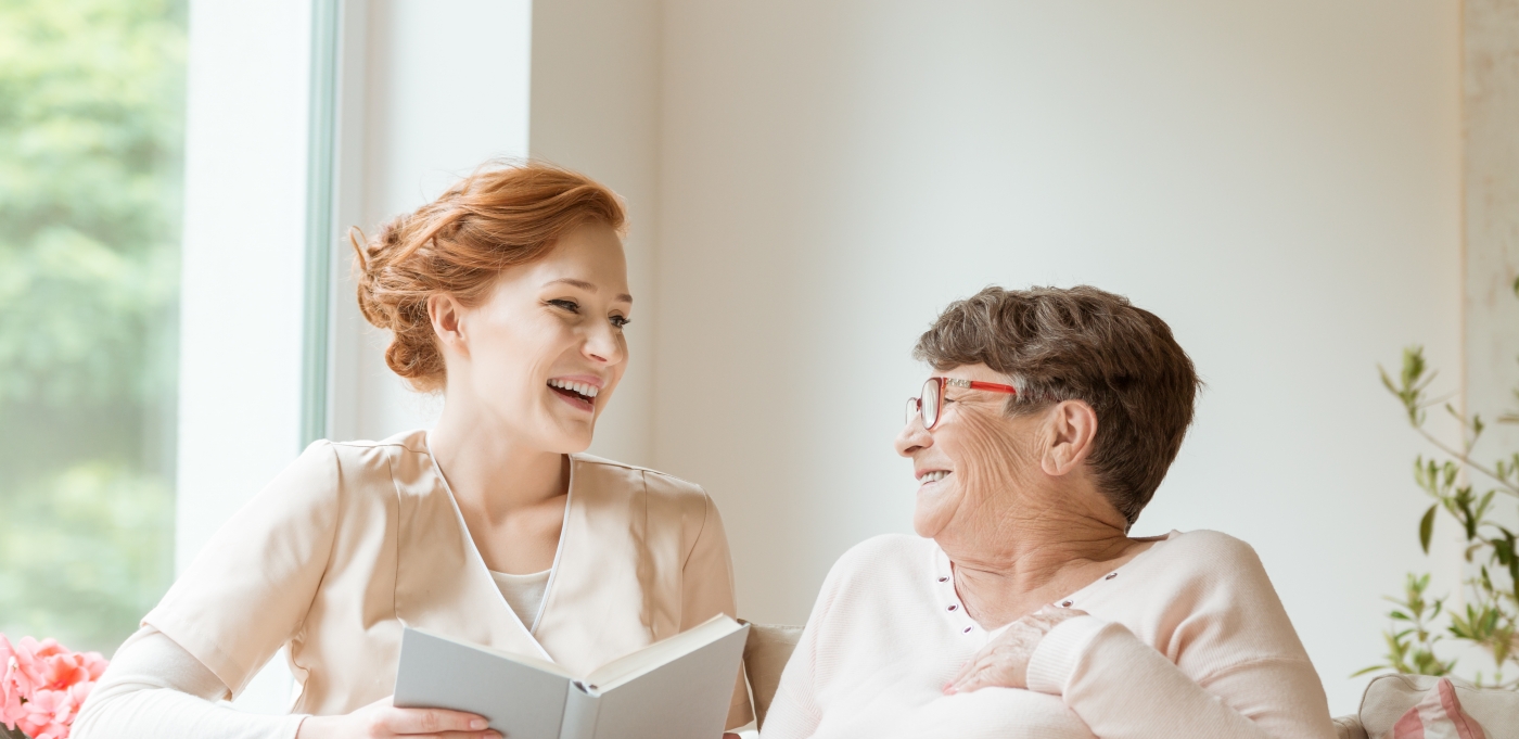 rockwood retirement assisted living woman nurse reading to senior citizen