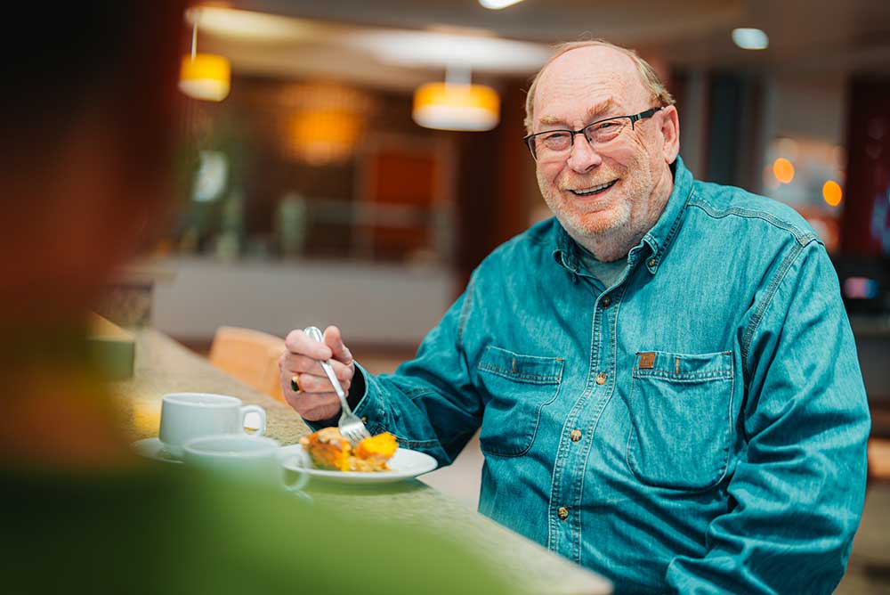 man eating a piece of pie