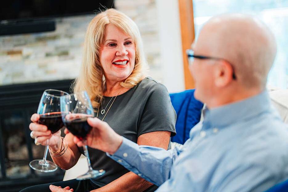 Couple toasting with wine at home