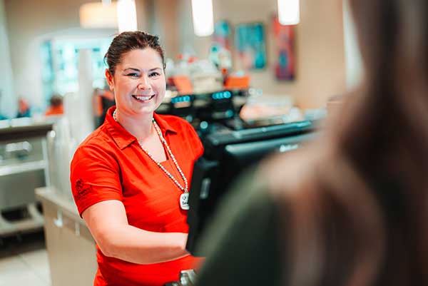 Smiling woman at a cash register