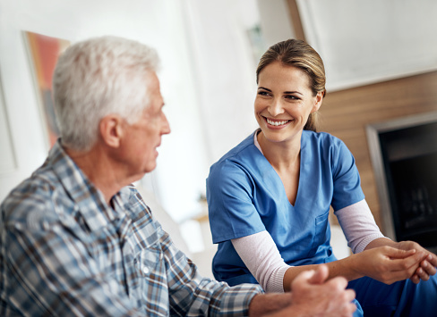 Nurse speaking to an elderly man