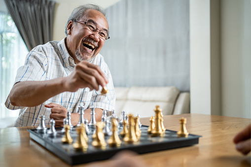 Man smiling and playing chess